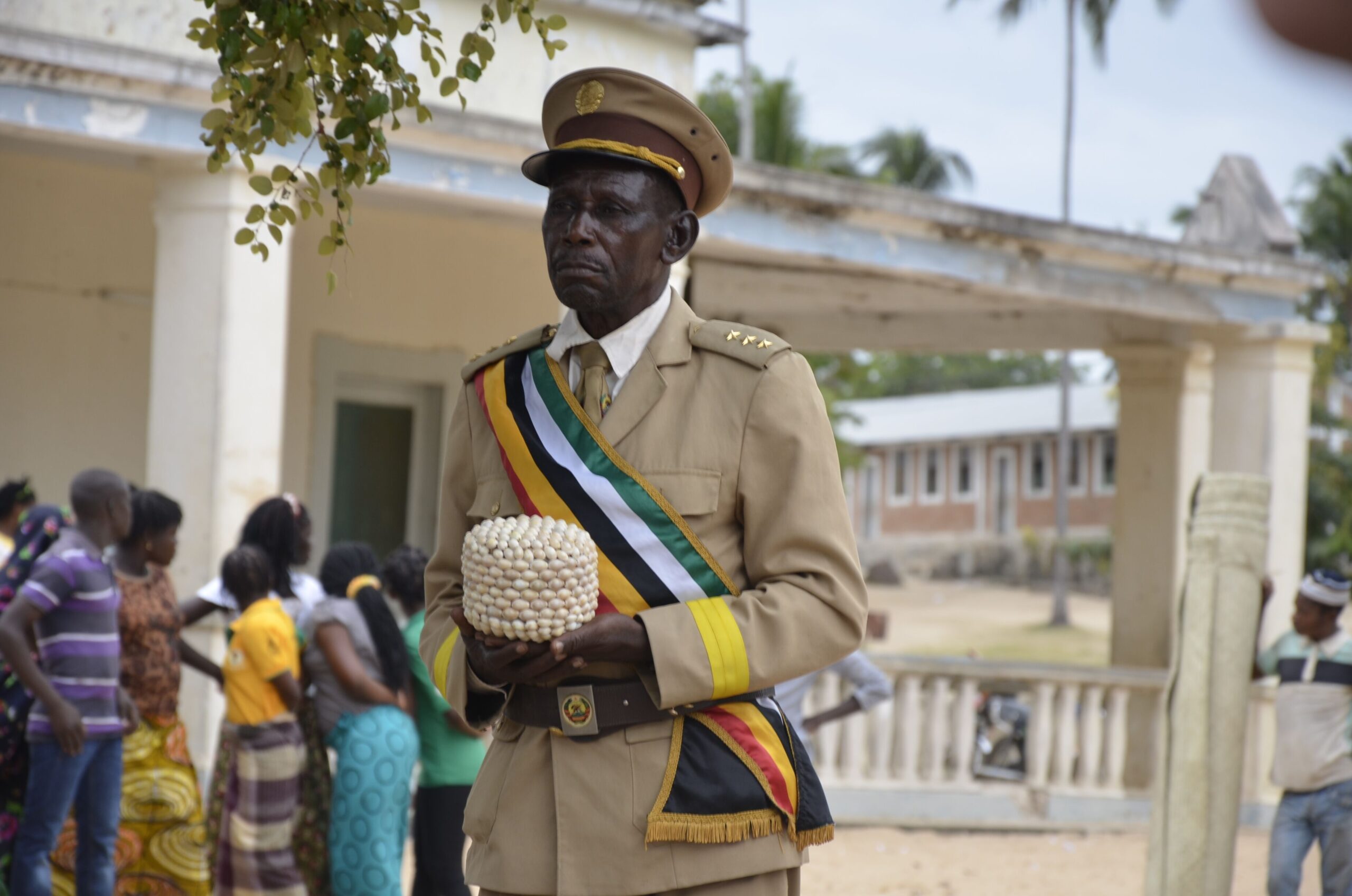 Evano Nhogache, traditional community leader of Mossuril, Mozambique, entrusting soil to NMAAHC founding director Lonnie Bunch, at a ceremony honoring the captives aboard the São José, 2015. Photo by Kamau Sadiki.