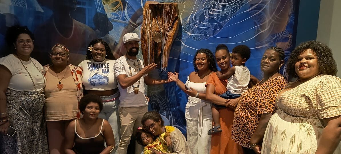 Collection of people standing in front of a statue 